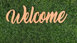 the word Welcome on green grass